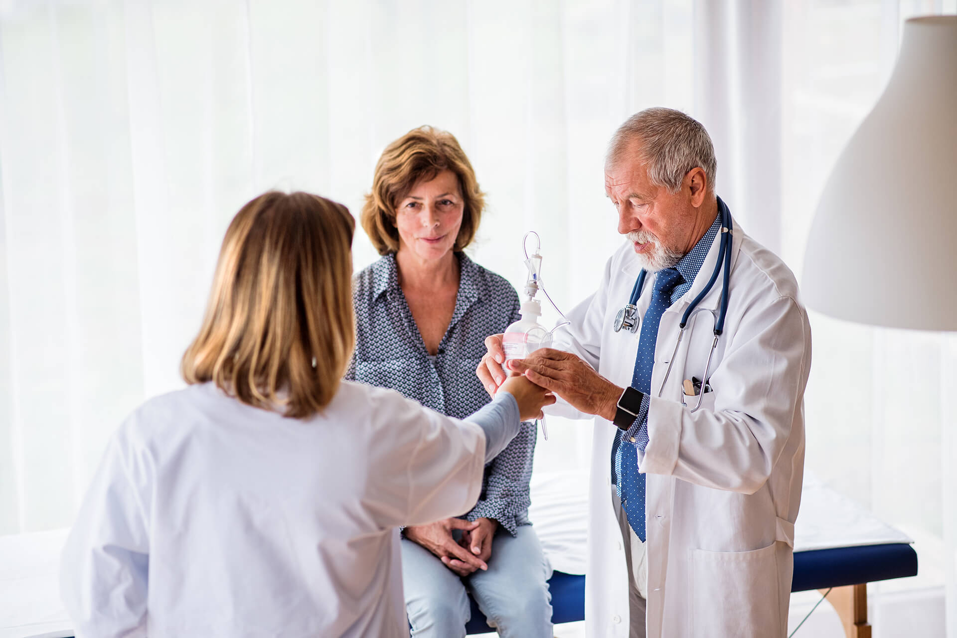 senior-doctor-examining-a-senior-woman-in-office-PTKXK5W.jpg